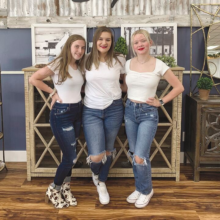 Farmhouse Style Boutique staffers, from left, Haley McElligott, Abbey Partney and Grace Gentry.